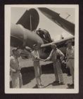 Photograph of Marines in front of a plane